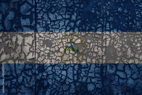 flag of nicaragua on a old grunge metal rusty cracked wall background © luzitanija