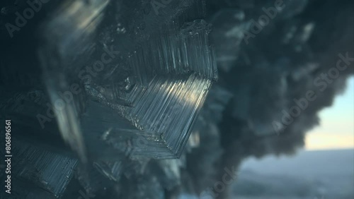 Close up ice crystal, sharp ice snowflakes on stalactites inside frozen cave  photo