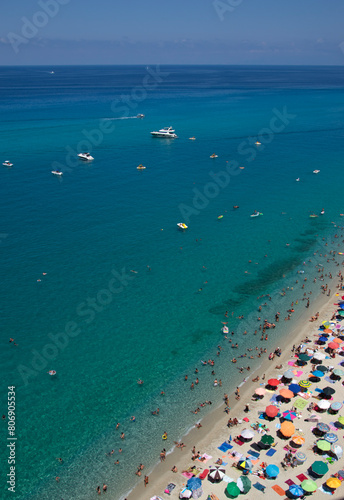 Fototapeta Naklejka Na Ścianę i Meble -  Aerial view of sandy beach with swimming people in sea with transparent blue water in summer.