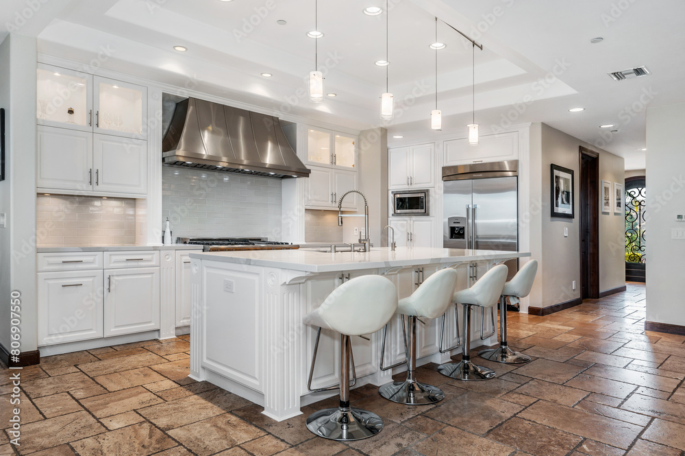 Fototapeta premium an open kitchen with four bars and stools in it