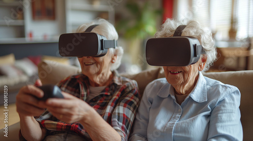 Two older women playing a computer game with virtual reality helmets sitting on the couch.