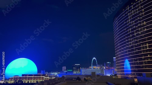 Stunning cityscape of Las Vegas at night with the futuristic Sphere illuminated with blue ocean and whales, the Wynn Hotel and the High Roller in foreground - Nevada, USA photo