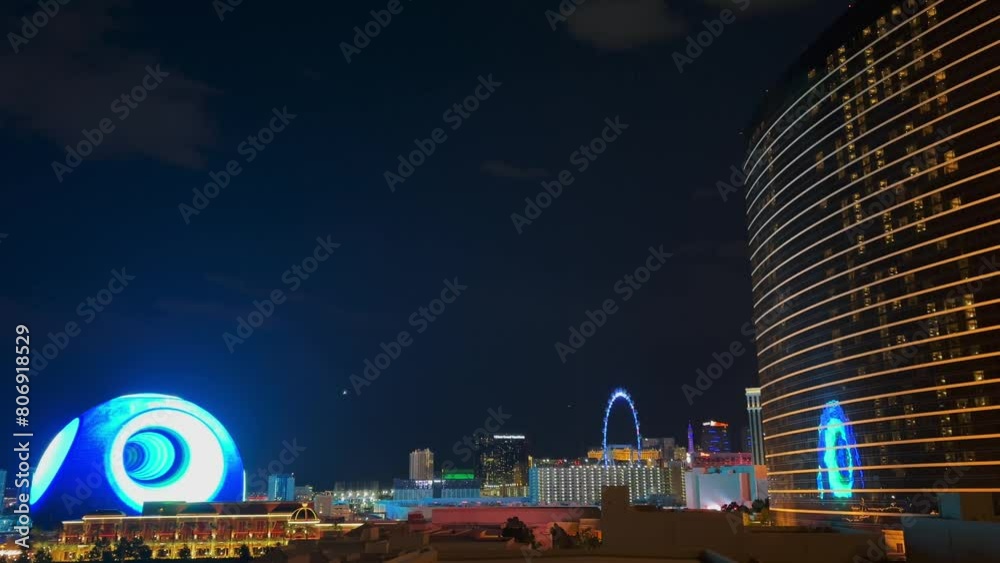 Cityscape of Las Vegas at night with the futuristic Sphere illuminated with a psychedelic blue pattern, the Wynn Hotel and the High Roller in the foreground - Nevada, USA