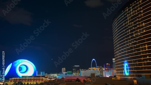 Cityscape of Las Vegas at night with the futuristic Sphere illuminated with a psychedelic blue pattern, the Wynn Hotel and the High Roller in the foreground - Nevada, USA