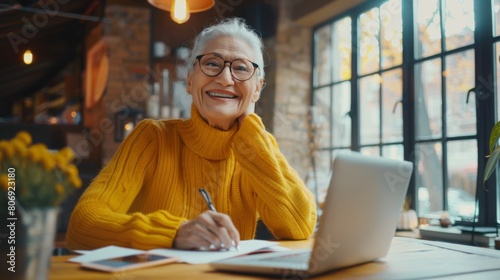 Cheerful Senior Woman with Laptop photo