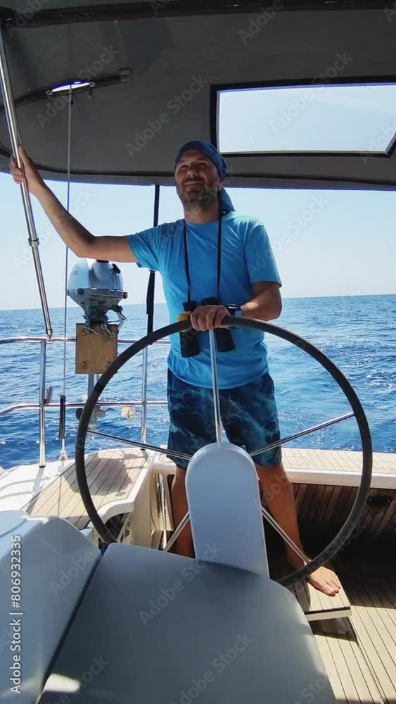 A man with binoculars controls a yacht. Vertical Video. Vertical Video A man with binoculars controls a yacht. Vertical Video. Vertical Video
