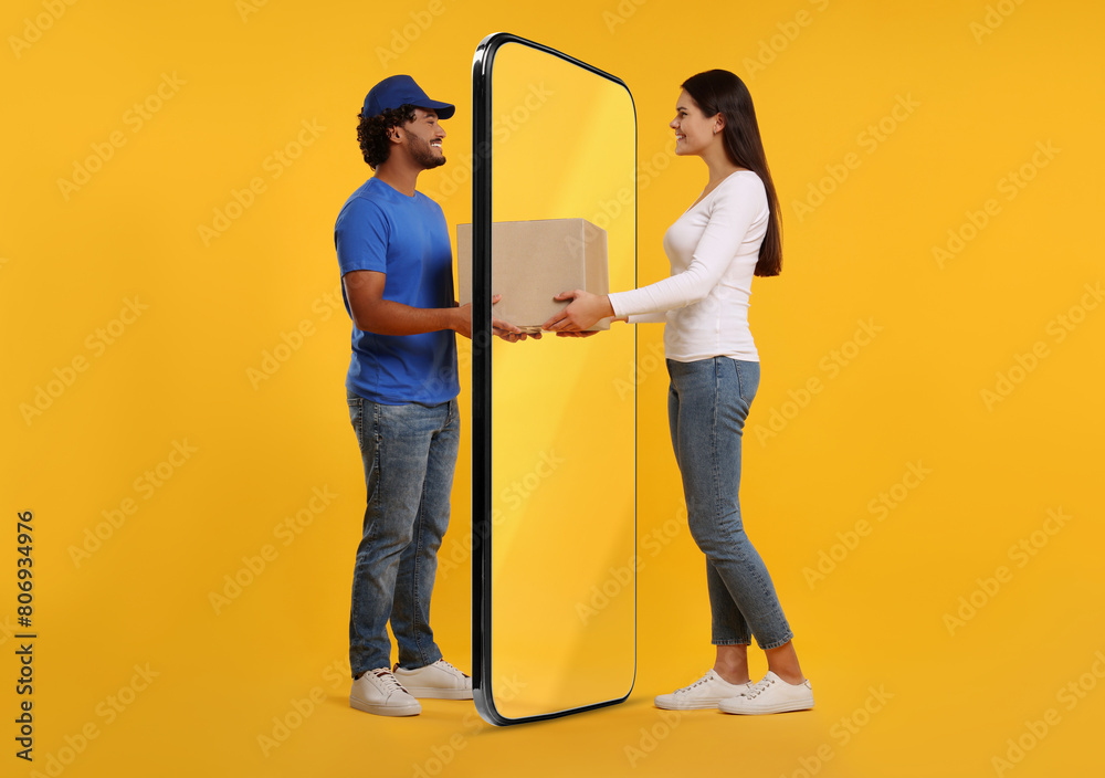 © New Africa - Courier delivering parcel to woman through huge smartphone on orange background © New Africa - Courier delivering parcel to woman through huge smartphone on orange background