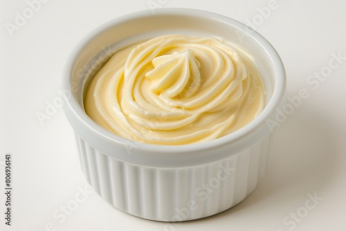 Swirl of creamy dessert in white ramekin on isolated background photo