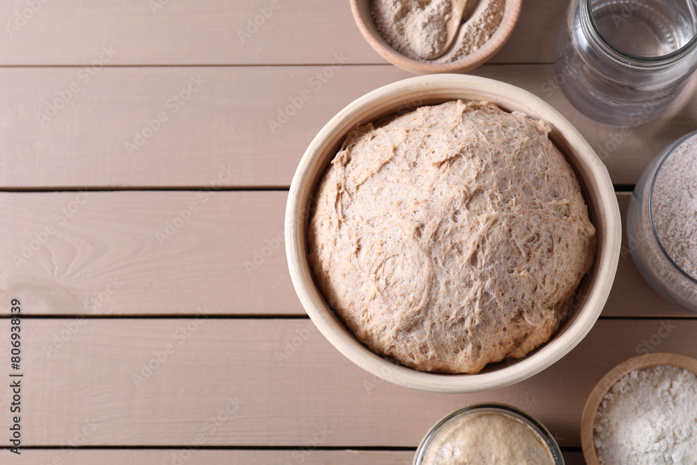 Fresh sourdough, flour and water on wooden table, flat lay. Space for text Fresh sourdough, flour and water on wooden table, flat lay. Space for text