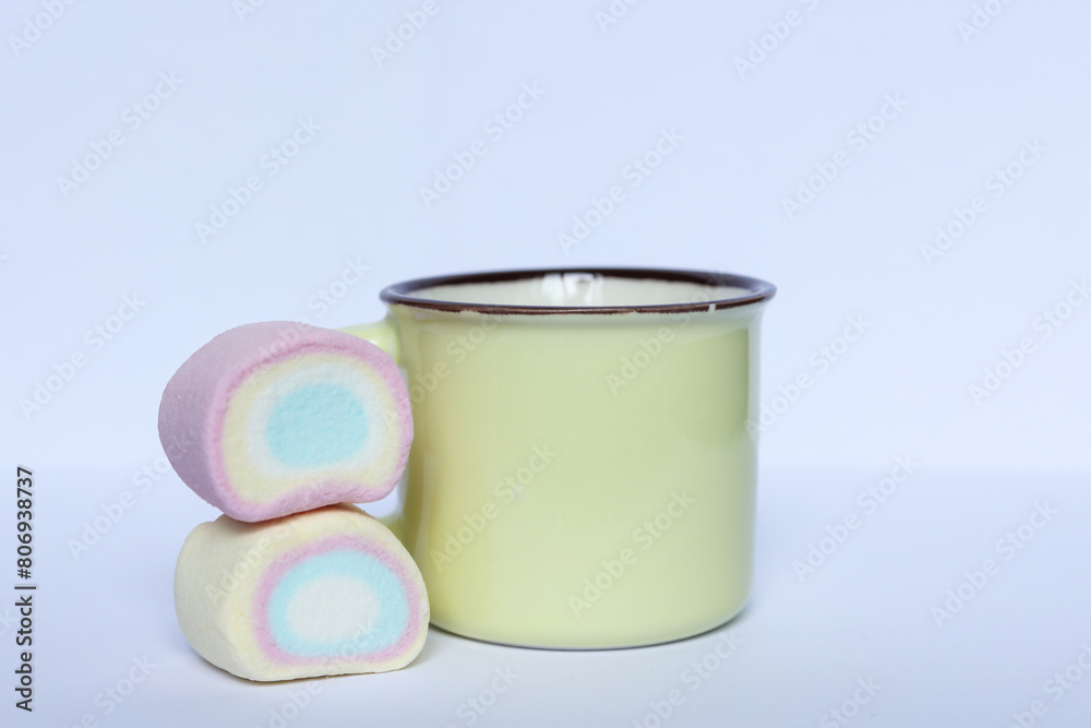 pastel color cup and marshmallows on white background pastel color cup and marshmallows on white background