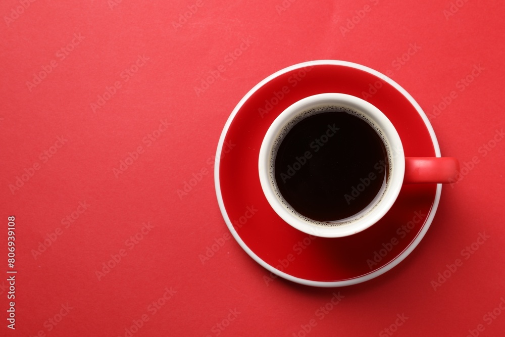 Aromatic coffee in cup on red background, top view. Space for text Aromatic coffee in cup on red background, top view. Space for text