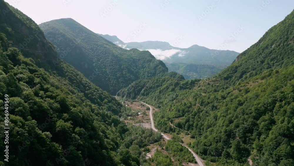 drone flight over a green gorge with mountains, road to the gorge, aerial view drone flight over a green gorge with mountains, road to the gorge, aerial view