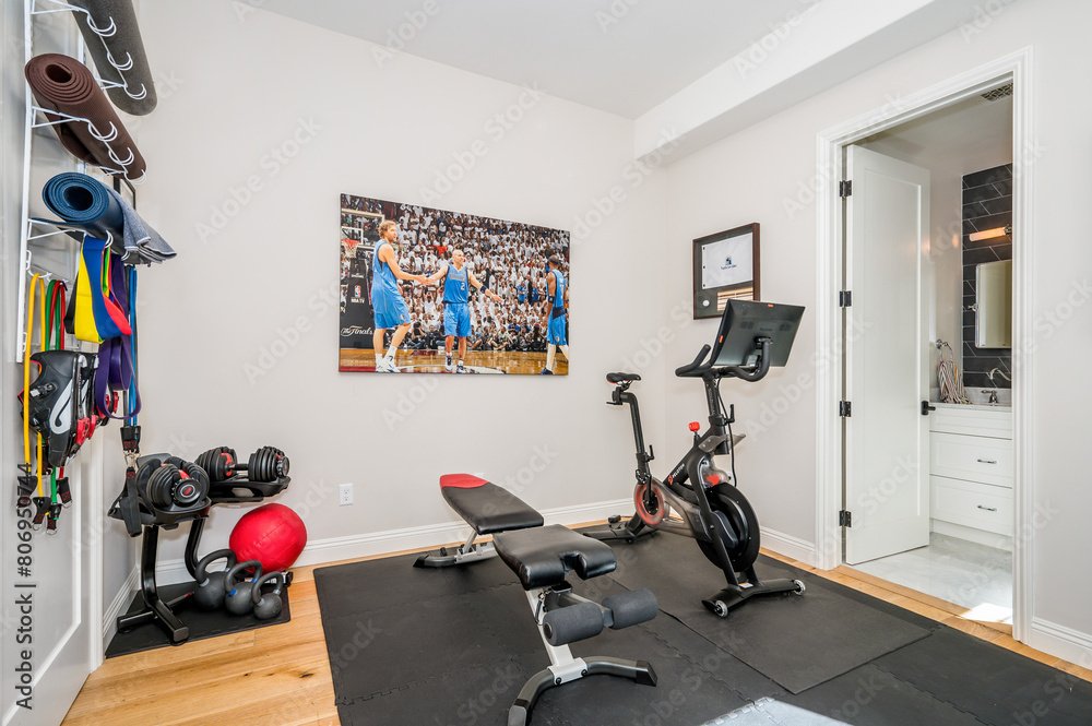 Fototapeta premium a gym with some equipment on the floor and a painting