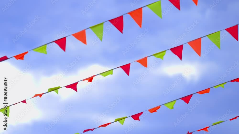 Colorful flags fluttering in the breeze, creating a mesmerizing display of movement and color. Colorful flags fluttering in the breeze, creating a mesmerizing display of movement and color.