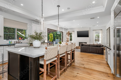 an open kitchen with wooden floors and white cabinets is shown