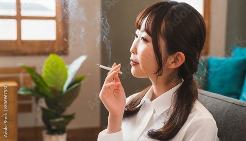 部屋の中で、おいしそうにタバコを吸う女性 photo