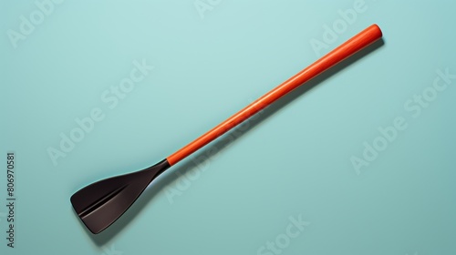 Orange and black spatula on a vibrant blue background photo
