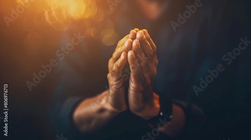 closeup of praying hands clasped together dramatic lighting on dark background spiritual devotion concept