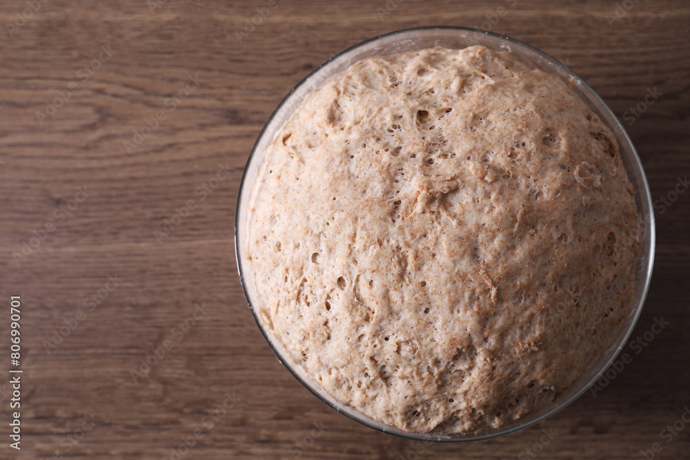 Fresh sourdough in bowl on wooden table, top view. Space for text Fresh sourdough in bowl on wooden table, top view. Space for text