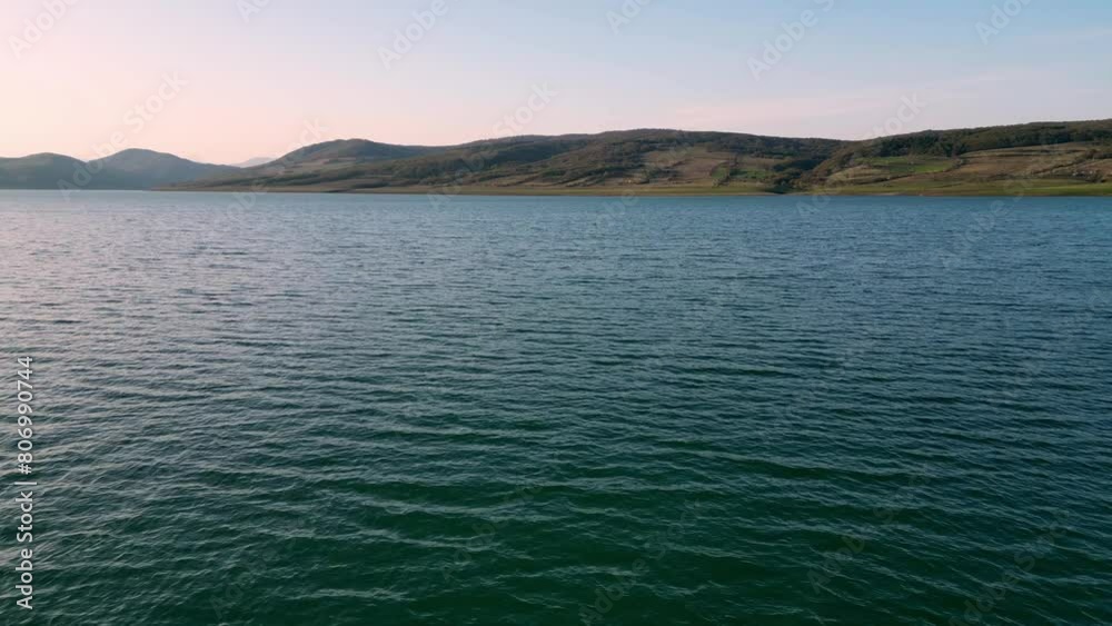 flying over water, over a mountain lake at sunset, aerial view flying over water, over a mountain lake at sunset, aerial view