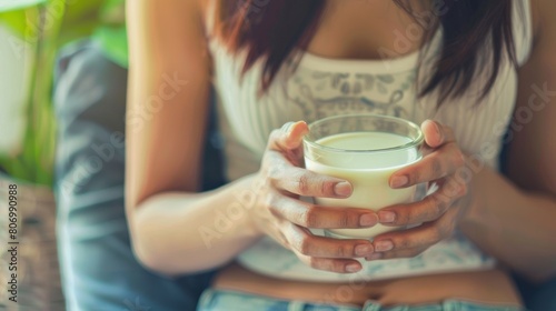 Lactose intolerance and Milk allergy concept. woman hold Milk glass and having abdominal cramps and pain when drink Cow Milk. photo