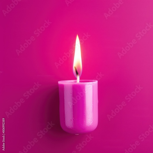 Magenta background with white thin wax candle with a small lit flame for funeral grief death dead sad emotion with copy space texture for display 