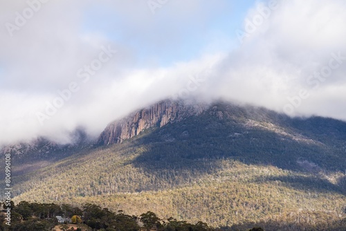 peak of a rocky mountain in a national park looking over a city below, mt wellington hobart tasmania australia in summer photo