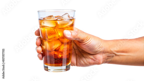 A hand holding a glass of iced tea