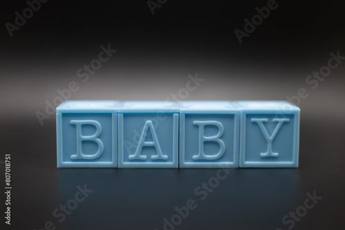 Blue baby blocks on a black background 
