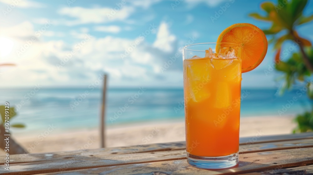 Fresh orange cocktail on wooden table. Blur beach on background Fresh orange cocktail on wooden table. Blur beach on background