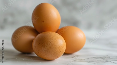 Fresh Brown Eggs Stacked on Marble Surface