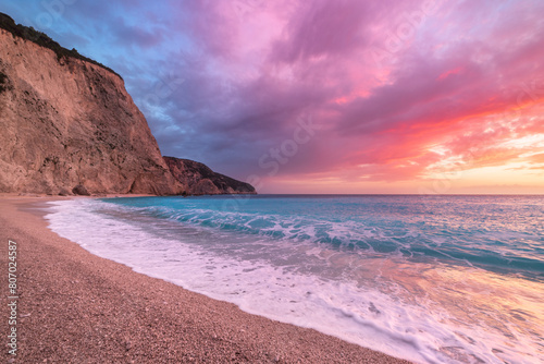 Beautiful beach and water bay in the greek spectacular coast line. Sunset gorgeous sky over blue water unique rocky cliffs. Greece summer top travel destination Lefkada island