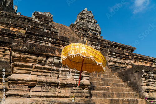 Yellow umbrella in Ta Keo, Angkor, Cambodia photo