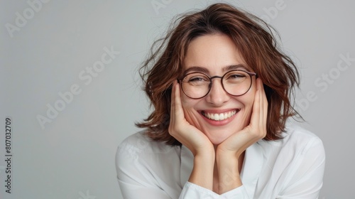 A Cheerful Businesswoman With Glasses Poses With Her Hands Under Her Face, Showing Happiness, Background HD For Designer 