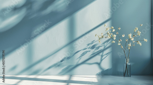 Minimalist composition of delicate white flowers in a blue vase against a soft blue wall with shadow patterns. Empty copy space for design. Generative AI