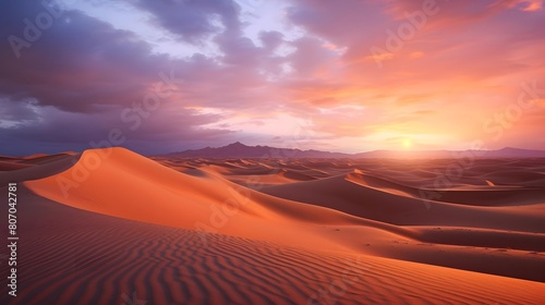 Desert sunset panorama with sand dunes and mountains in background
