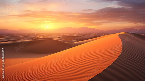 Panoramic view of sand dunes in desert at sunset.