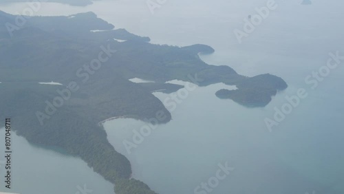 view above the sky while flying over open sea bay coastline with many tropical islands in sounthern of thailand photo