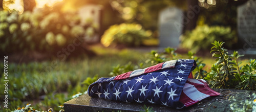 A close-up shot of a folded American flag resting on a soldier's grave on Memorial Day, the high-resolution image capturing the reverence and respect shown to those who made the ultimate sacrifice photo