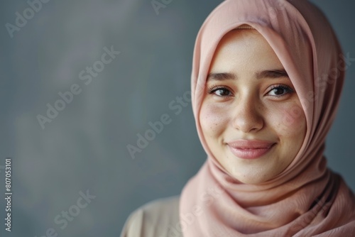 Portrait of young Asian Muslim woman smiling in hijab.
