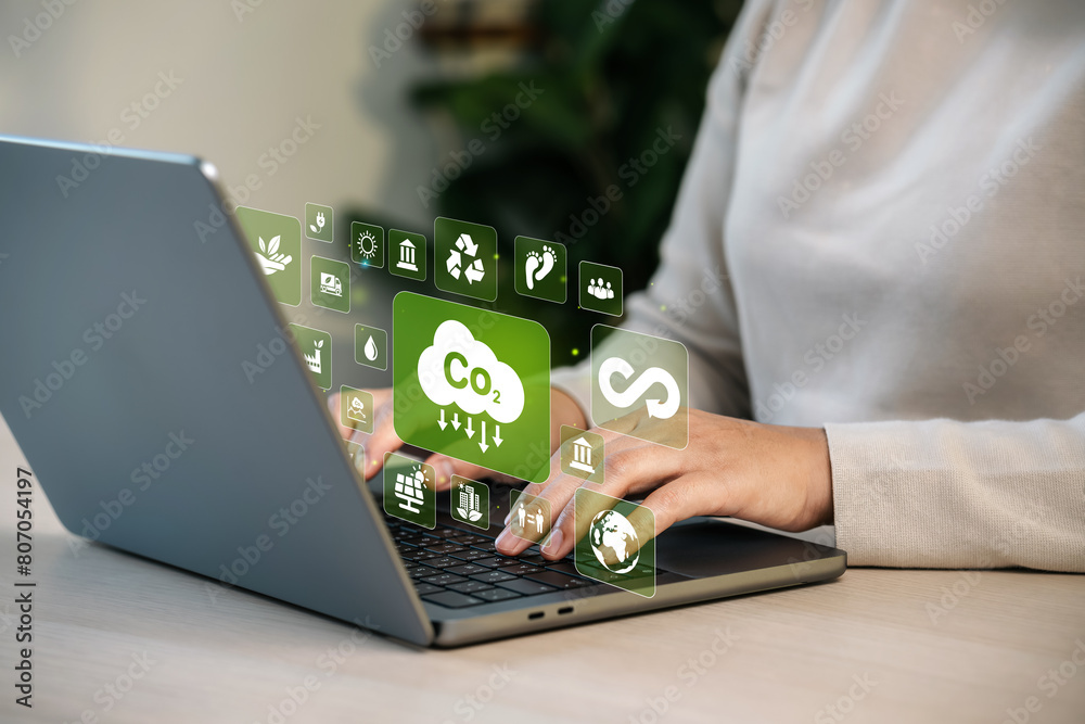carbon neutral concept Net zero greenhouse gas emissions target Woman using computer to analyze Carbon neutral with icon near computer screen in business investment strategy concept. carbon neutral concept Net zero greenhouse gas emissions target Woman using computer to analyze Carbon neutral with icon near computer screen in business investment strategy concept.
