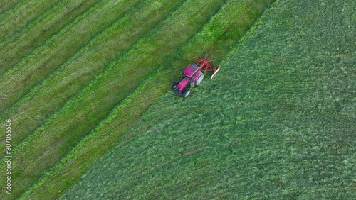 Red tractor cutting the grass in meadows in the Carranza Valley. Region encartaciones. Bizkaia. Basque Country. Spain. Europe photo