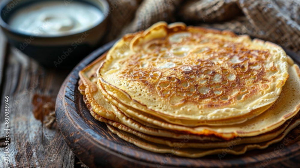 A close-up of a stack of golden brown roti pancakes, served on a rustic wooden plate with a side of sweetened condensed milk for dipping. A close-up of a stack of golden brown roti pancakes, served on a rustic wooden plate with a side of sweetened condensed milk for dipping.