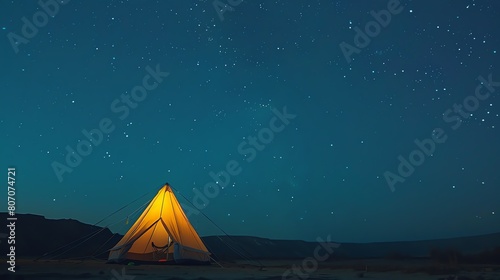 Under a sky full of stars  a lone tent stands in the desert. The warm glow from inside the tent contrasts with the cool night air.