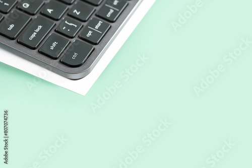 Wireless keyboard with sheet of paper.