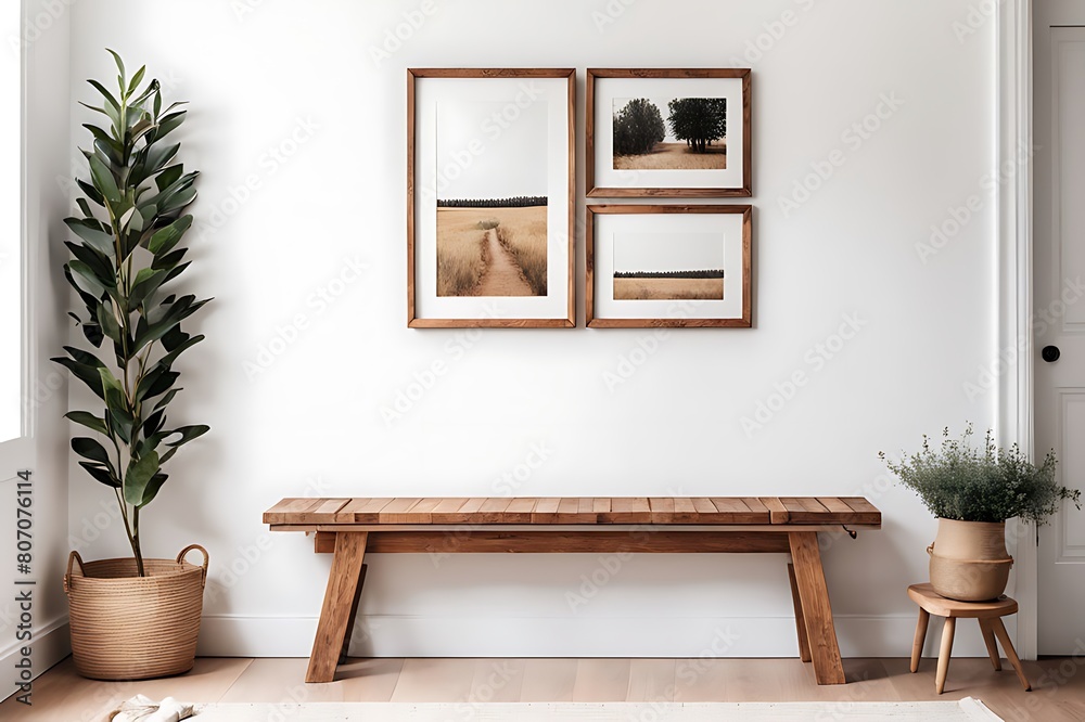 Wooden rustic bench near white wall with frames. Farmhouse, country, boho interior design of modern home entryway, hall. Wooden rustic bench near white wall with frames. Farmhouse, country, boho interior design of modern home entryway, hall.