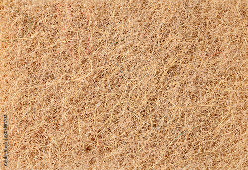 Abstract background made of soft fabric with long pile of beige color, macro photo