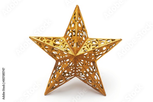 A close-up view of an intricate golden star with a cut-out design  isolated on a white background