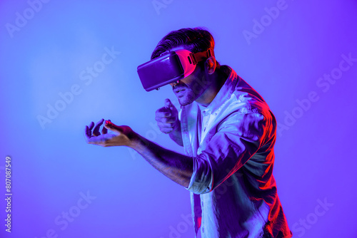Side view of man wearing VR glass and moving gesture holding gun. Gamer using future digital virtual reality headset or futuristic innovation to enter meta world or playing action game. Deviation.