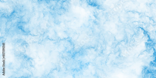 Beautiful brush painted cloudy blue-sky background. Blue sky background and white blurry, clear, and puffy clouds. Winter seasonal cloudscape covered puffy and fresh blue-sky romantic background. 